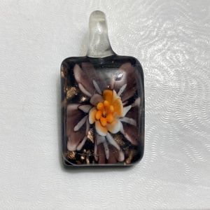 LEAVING CLOSET! Glass charm. No chain. Purple flowers on 1 side. Black on other.